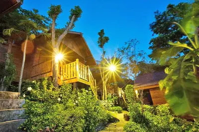a wooden house with a deck on the side of it at The Cobble Beach Hotel- Phi Phi Island in Phi Phi Don