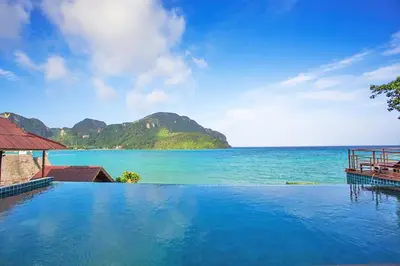 a swimming pool with a view of the ocean at The Cobble Beach Hotel- Phi Phi Island in Phi Phi Don