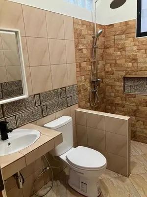 a bathroom with a toilet and a sink and a shower at Cozy Private Pool Villa For Family - Halal in Ban Thalat Choeng Thale