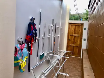 a room with a wall with a bunch of rackets at Cozy Private Pool Villa For Family - Halal in Ban Thalat Choeng Thale