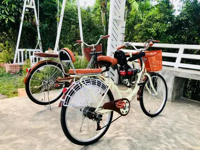 two bikes parked next to each other on a swing at Cozy Private Pool Villa For Family - Halal in Ban Thalat Choeng Thale