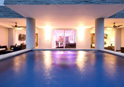 a swimming pool in a house with a living room at The Blue Bay Experience in Kata Beach