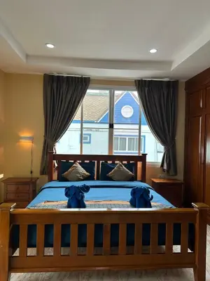 a bedroom with a bed with blue teddy bears on it at BT hotel Kata Beach in Kata Beach