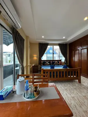 a hotel room with a table and a bed at BT hotel Kata Beach in Kata Beach