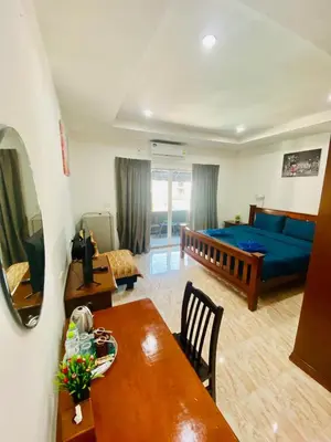 a living room with a bed and a dining table at BT hotel Kata Beach in Kata Beach