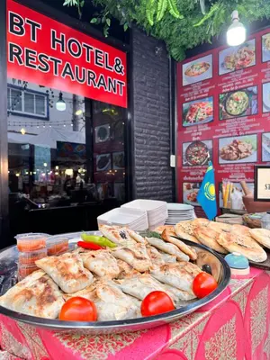 a buffet of food on a table in front of a restaurant at BT hotel Kata Beach in Kata Beach