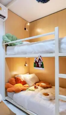 a bunk bed with lots of stuffed animals on it at Airhub Hostel Phuket Airport in Nai Yang Beach