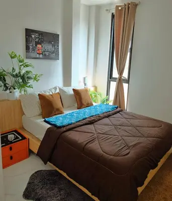 a bedroom with a bed and a window at Airhub Hostel Phuket Airport in Nai Yang Beach