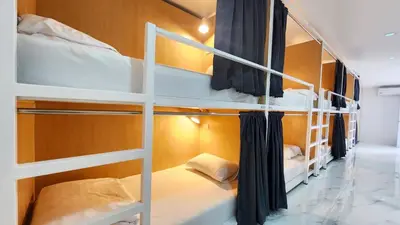 a room with three bunk beds in it at Airhub Hostel Phuket Airport in Nai Yang Beach