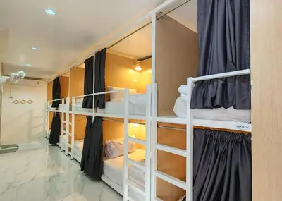 a room with two bunk beds in it at Airhub Hostel Phuket Airport in Nai Yang Beach