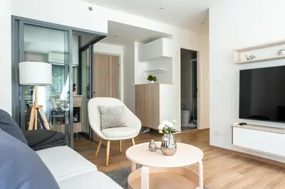 a living room with a couch and a tv at Phyll Phuket 2 BR apartment near Central Festival by NLA in Phuket Town