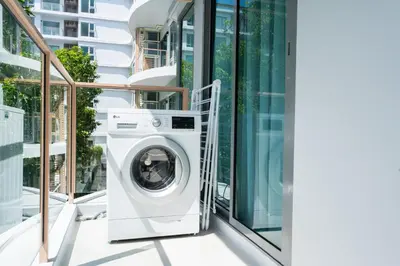 a washing machine on the balcony of a building at Phyll Phuket 2 BR apartment near Central Festival by NLA in Phuket Town