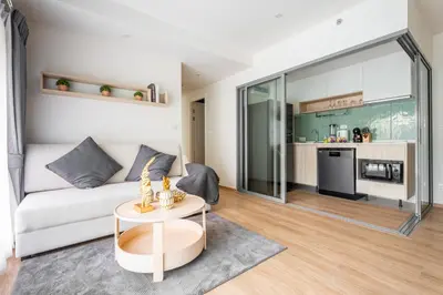 a living room with a couch and a table at Phyll Phuket 2 BR apartment near Central Festival by NLA in Phuket Town