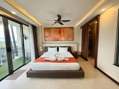 a bedroom with a bed and a ceiling fan at Large Luxurious 1-bedroom condos in Rawai in Rawai Beach