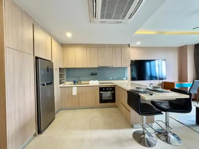 a kitchen with a refrigerator and a table and chairs at Large Luxurious 1-bedroom condos in Rawai in Rawai Beach
