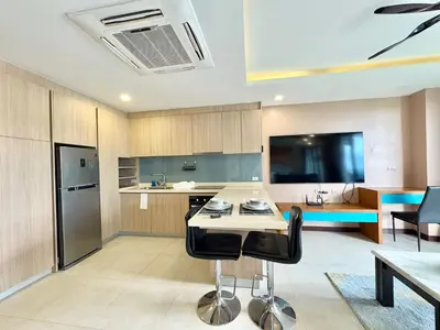 a kitchen with a table and two black chairs at Large Luxurious 1-bedroom condos in Rawai in Rawai Beach