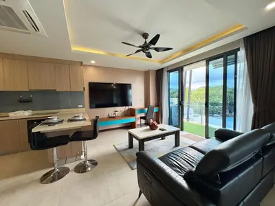 a living room with a couch and a table at Large Luxurious 1-bedroom condos in Rawai in Rawai Beach