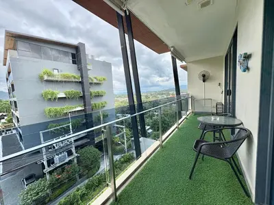 a balcony with a table and chair on a building at Large Luxurious 1-bedroom condos in Rawai in Rawai Beach