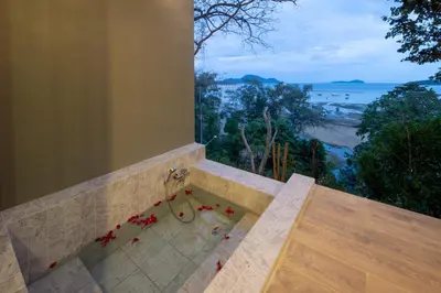 a bathroom with a pool with a view of the ocean at Nature Vista Rawai in Nai Harn Beach