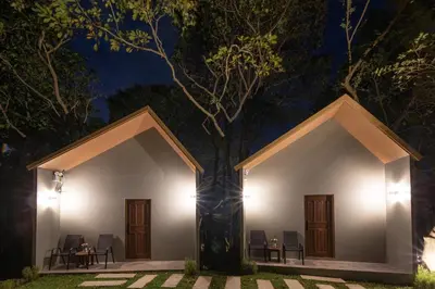 a house in the middle of a forest at night at Nature Vista Rawai in Nai Harn Beach
