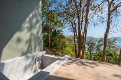 a view from the balcony of a house at Nature Vista Rawai in Nai Harn Beach