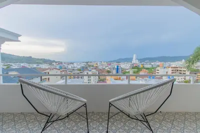 two chairs sitting on a balcony with a view at The Va Phuket Patong in Patong Beach