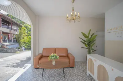 a brown leather chair in a room with a table at The Va Phuket Patong in Patong Beach