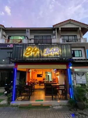 a restaurant with a sign on the side of a building at 84 Bar & Guest House in Ban Huai Luk (1)
