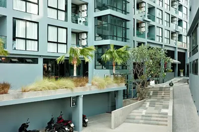an apartment building with motorcycles parked outside of it at City Gate Kamala B607 by Phuket Sabay Rent in Kamala Beach