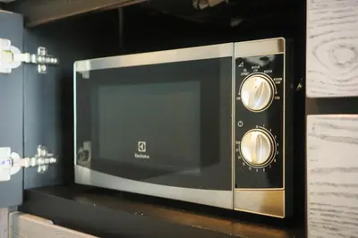 a microwave oven sitting on top of a shelf at City Gate Kamala B607 by Phuket Sabay Rent in Kamala Beach