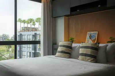 a bedroom with a large bed with a large window at City Gate Kamala B607 by Phuket Sabay Rent in Kamala Beach