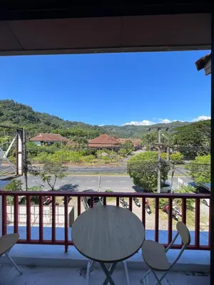 a view of a balcony with a table and chairs at Petunya Room 3 in Ban Huai Luk (1)