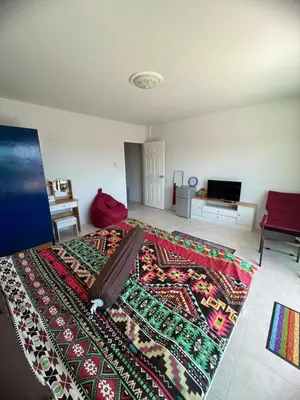 a bedroom with a large bed with a rug on it at Petunya Room 4 in Ban Huai Luk (1)