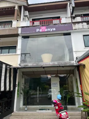 a scooter parked in front of a building at Petunya Room 4 in Ban Huai Luk (1)