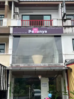 a window of a building with a sign on it at Petunya Room 4 in Ban Huai Luk (1)