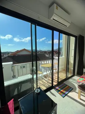 a view of a living room with a large glass window at Petunya Room 4 in Ban Huai Luk (1)