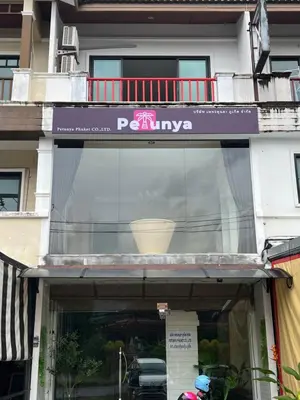 a window of a building with a sign on it at Petunya Room 4 in Ban Huai Luk (1)