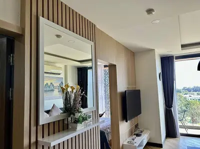 a bedroom with a large mirror and a tv at Calypso rawai seaview apartment 600m walk to beach C4 in Phuket Town