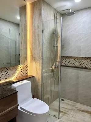 a bathroom with a toilet and a glass shower at Calypso rawai seaview apartment 600m walk to beach C4 in Phuket Town
