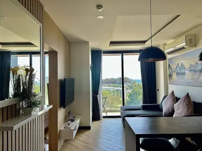 a living room with a couch and a table at Calypso rawai seaview apartment 600m walk to beach C4 in Phuket Town