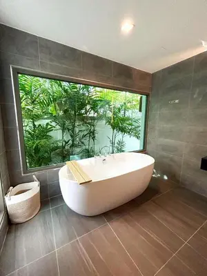 a bathroom with a large window and a bath tub at A spacious Balinese style villa with a large swimming pool on Rawai an electric motorcycle as a gift! in Ban Saiyuan (1)