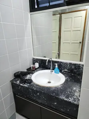 a bathroom with a sink and a mirror at 2 Bedroom apartments 1 min to sea in Patong Tower in Patong Beach