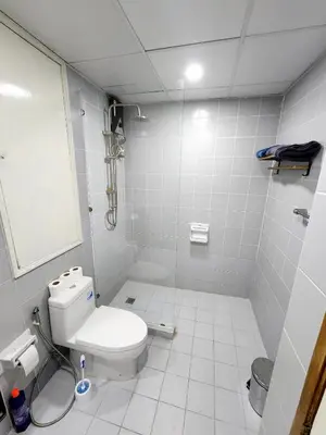 a white bathroom with a toilet and a shower at 2 Bedroom apartments 1 min to sea in Patong Tower in Patong Beach