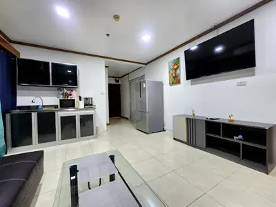 a living room with a couch and a flat screen tv at 2 Bedroom apartments 1 min to sea in Patong Tower in Patong Beach