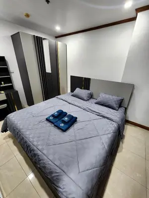a bed with two blue pillows on top of it at 2 Bedroom apartments 1 min to sea in Patong Tower in Patong Beach