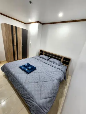a bedroom with a bed with blue pillows on it at 2 Bedroom apartments 1 min to sea in Patong Tower in Patong Beach