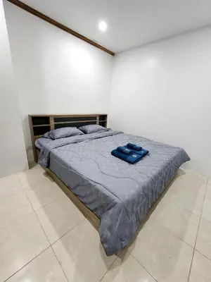 a bedroom with a bed with blue sheets on it at 2 Bedroom apartments 1 min to sea in Patong Tower in Patong Beach