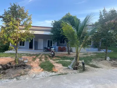 a house with a palm tree in front of it at Baanchomjan Kohyaoyai in Ban Nai Wat