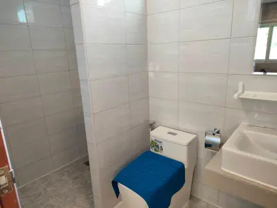 a small bathroom with a toilet and a sink at Baanchomjan Kohyaoyai in Ban Nai Wat