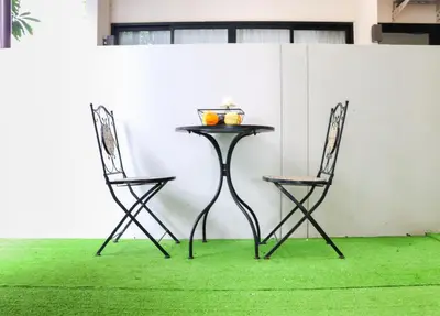 two chairs and a table and a table and chairs at Friendly Townhouse Laguna Park in Thalang